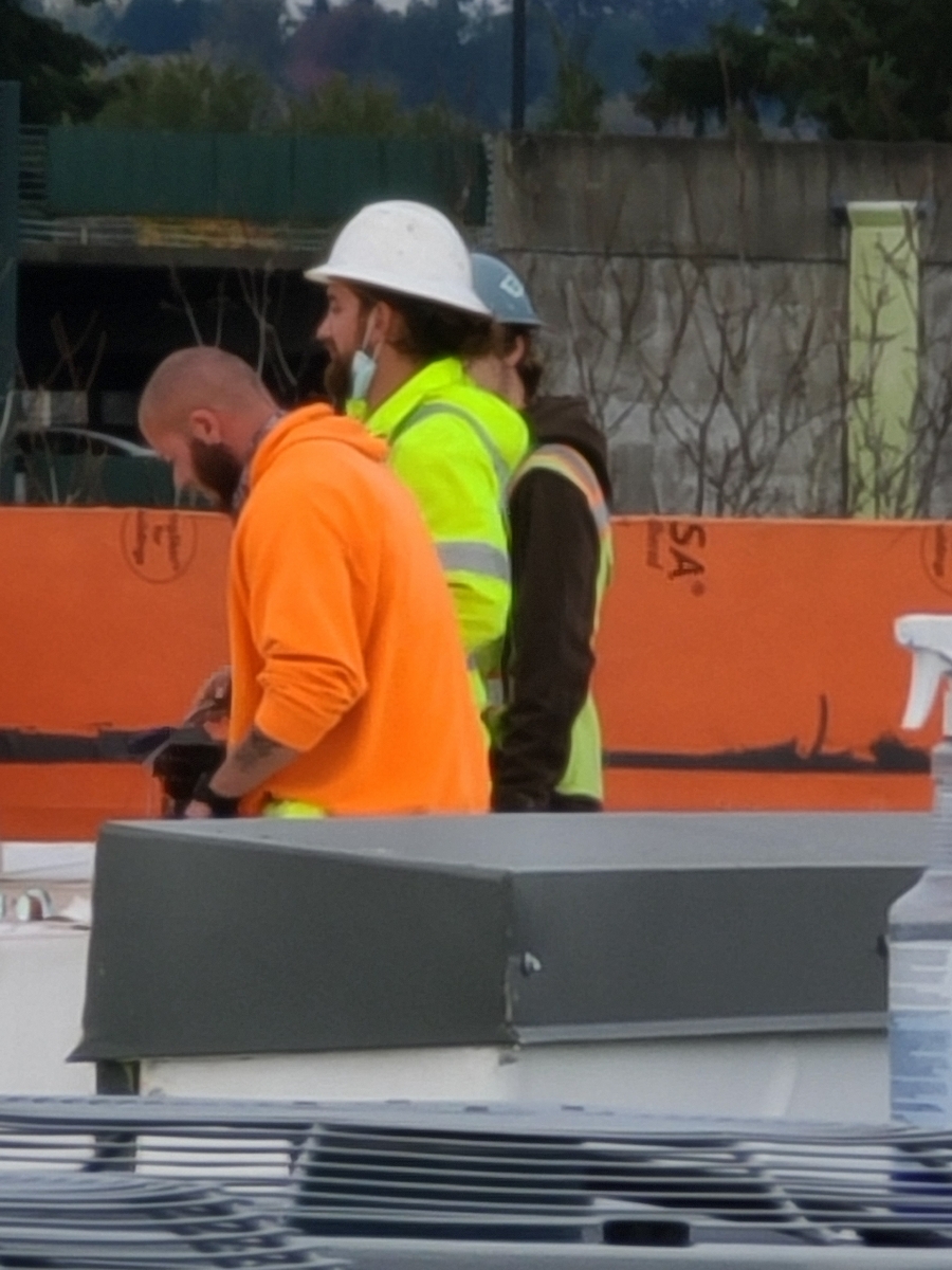 Seamcraft crew members working on a commercial rooftop